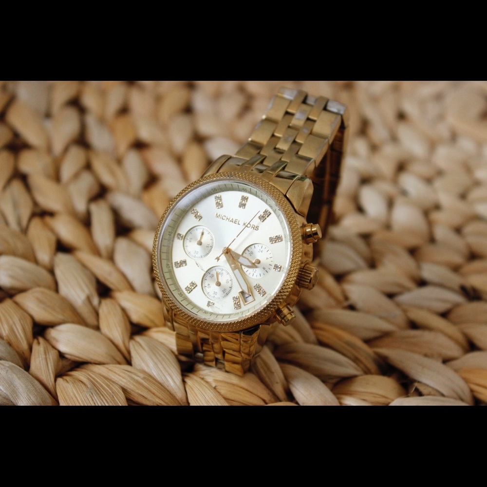 Michael Kors woman’s gold watch with crystal face